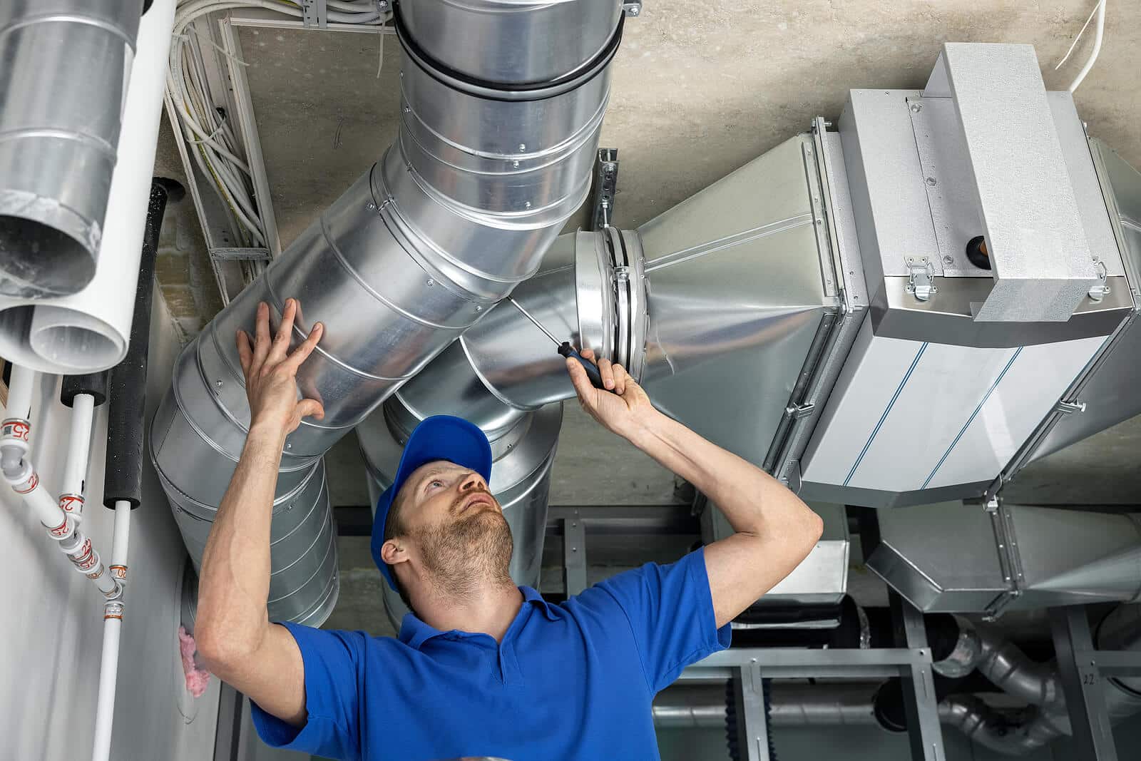 HVAC technician inspecting and repairing air ducts in San Juan Capistrano