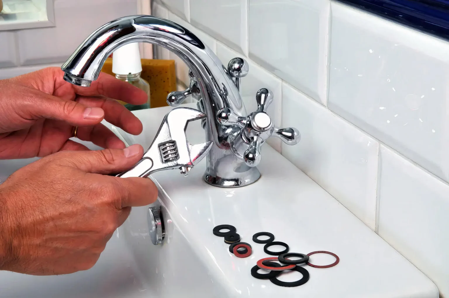 Plumber maintaining a bathroom faucet in San Juan Capistrano