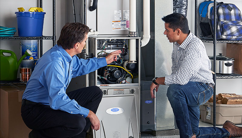 Technician evaluating a furnace for repair or replacement in San Juan Capistrano