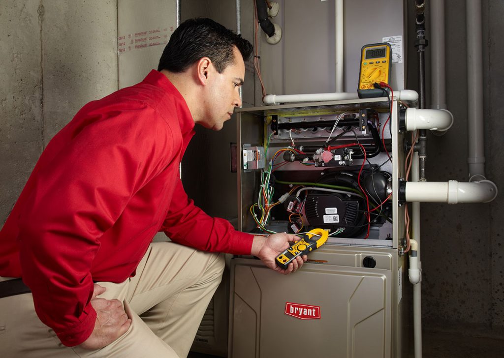 Heating technician diagnosing a furnace repair in San Juan Capistrano