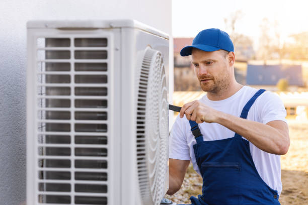 HVAC technician servicing an outdoor air conditioner in San Juan Capistrano