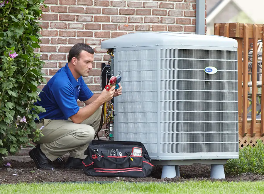 HVAC technician inspecting an outdoor AC unit in San Juan Capistrano